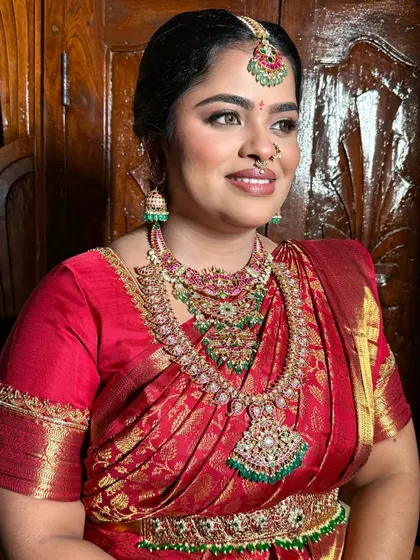 A beautiful portrait of Apoorva. Her makeup features a soft glam style with glossy eyes, creating a timeless and radiant bridal look.