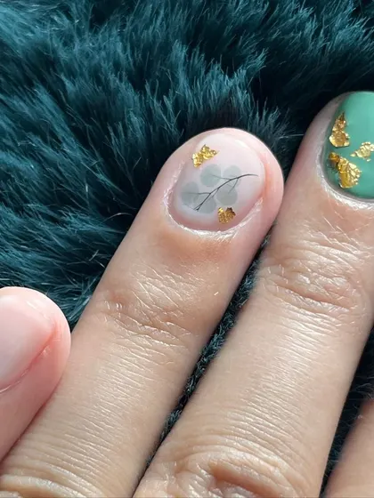 A close-up of the teal and marble design with delicate gold foil and leaf details.
