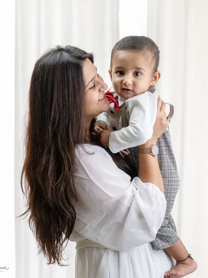A candid moment between a mother and her smartly dressed son. I love capturing these authentic interactions that show a family's personality.