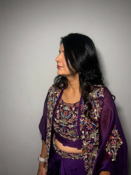 A side profile of this elegant lady ready for a wedding. I gave her soft waves and a natural makeup look that complemented her purple outfit.