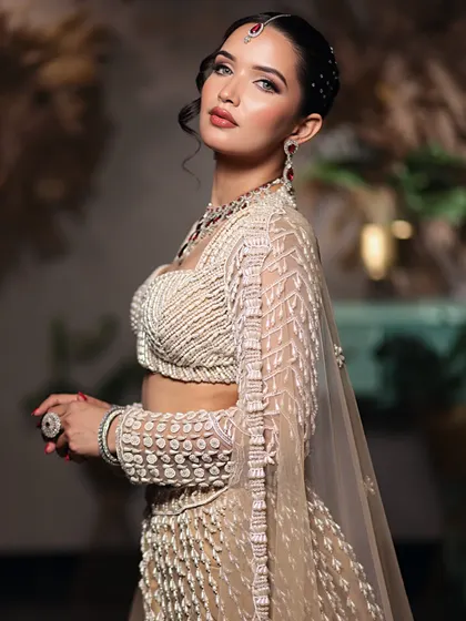 A side profile showcasing the elegant updo and the way the soft glam makeup enhances the model's features.