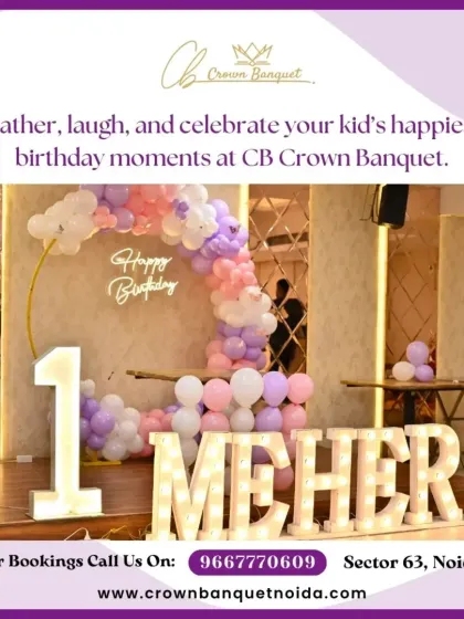 A first birthday celebration setup featuring a large light-up number '1' and name. The pastel balloon arch against a mirrored wall creates a modern and stylish look.