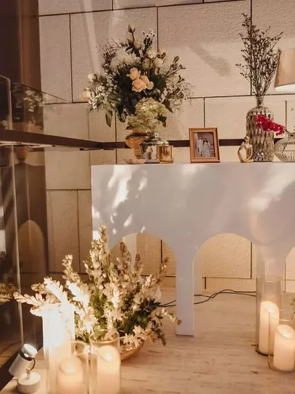 A closer look at one of the elegant console tables. We used a mix of classic lamps, photo frames, and floral arrangements to create vignettes that tell the couple's story.