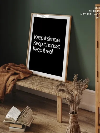 Our "Keep it simple" quote print, framed in natural wood with glass, adds a touch of sophistication to this rustic-modern entryway. The white text on a black background creates a bold statement.