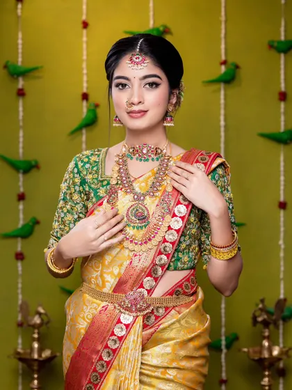 This is a beautiful look we created, featuring a kasu mala necklace paired with a choker. The yellow and green combination of the saree is so vibrant, and the jewellery adds a traditional yet fresh touch.