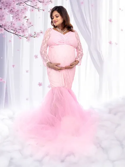 A beautiful full-length shot of a mom-to-be in a pink gown, surrounded by a soft cloud effect for a heavenly feel.