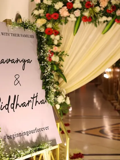 A welcome sign for the wedding of Lavanya and Siddhartha, adorned with delicate flowers. We capture the personalized details that tell your story.