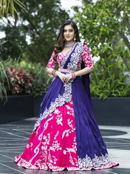 A bold and contemporary design featuring a sculpted skirt with 3D hand embroidery. The striking combination of pink and blue, detailed with graphic patterns in corded cut dana, makes this a true statement piece for a modern bride.