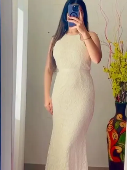 A mirror selfie from a client trying on the white lace gown before her event. It's all about finding that perfect fit!