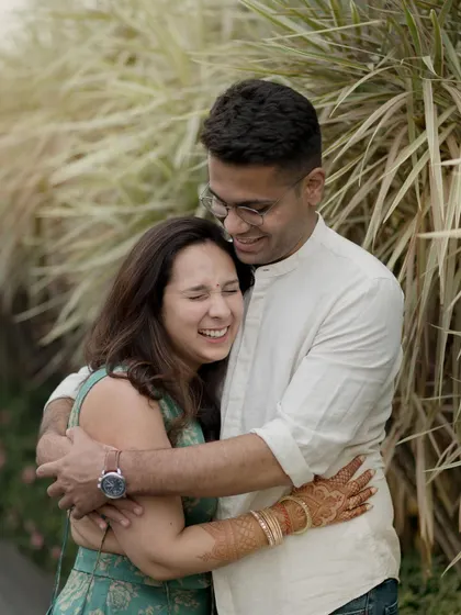 There is nothing better than a real, full-hearted laugh. This candid photo captures a couple sharing a joyful hug during their outdoor portrait session. My approach is to guide you gently, but the best shots always happen when you forget I'm even there.