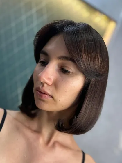 Another shot of the classic brown bob, showing off its sleek lines and face-framing shape.