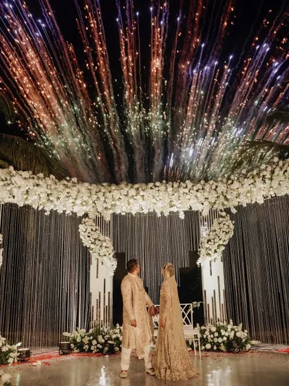 Under a sky full of fireworks, the couple shares a moment at their Goa wedding. The all-white mandap looked absolutely magical.