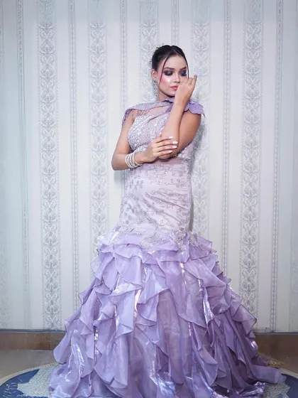 A full-length view of the lilac fish-cut gown with its dramatic ruffled skirt.