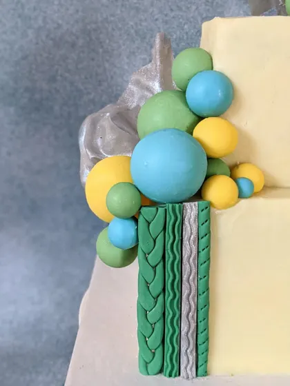 A close-up of the textured fondant details on a square tiered cake. I used various molds to create these knit and braided patterns, adding a tactile, modern element to the design.