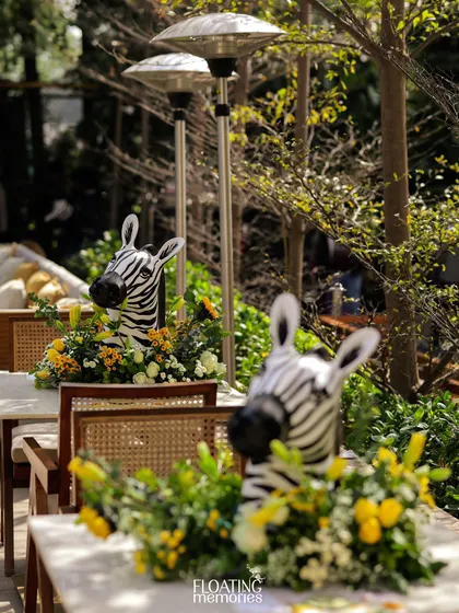 Even the table centerpieces joined the safari. These zebra heads emerging from floral arrangements added a fun and surprising touch for guests.