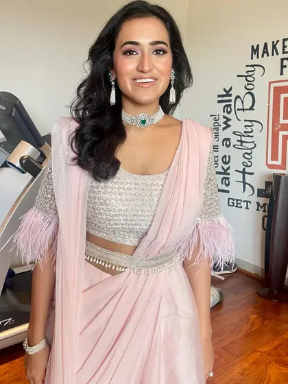 Fresh as a daisy for a party. This look features a pre-draped saree and soft, glowing makeup that is effortlessly chic.