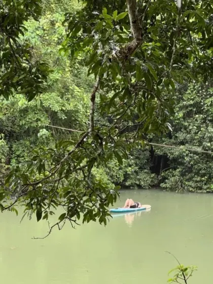 At water level, watching the rain fall into the pond. A moment of deep connection where you feel like a part of nature itself.
