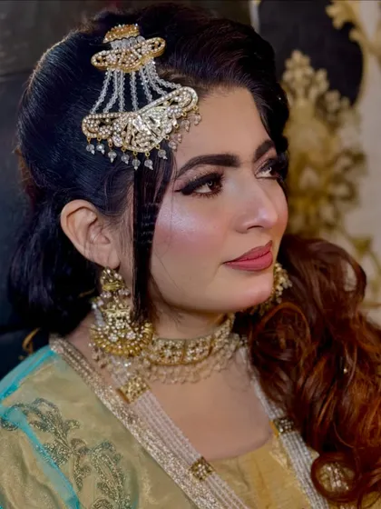 Another angle from the peacock feather shoot. The side-swept hair and intricate jhoomar add to the elegance of this creative look.