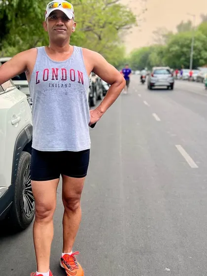 A member looking fit and proud during the anniversary run. We celebrate fitness and relationships.