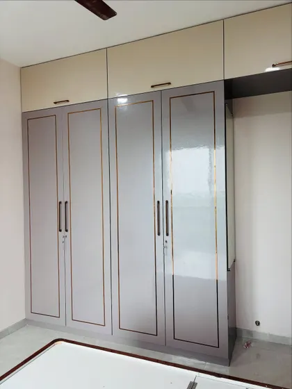 This view shows the full scale of the wardrobe with its loft cabinets, providing storage all the way up to the ceiling.