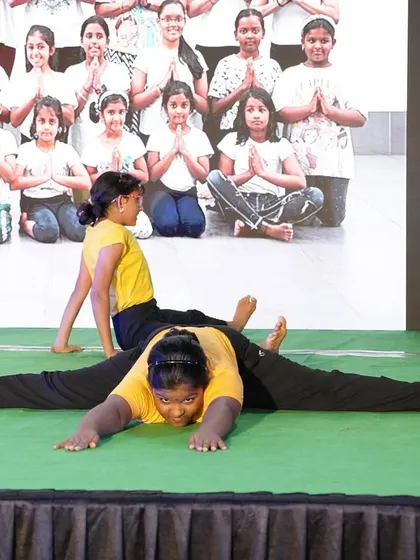 A close-up of the students' performance, showing their strength and flexibility on stage.