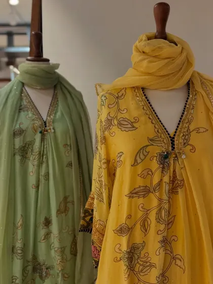 A closer look at the pastel green and yellow printed kurtas, highlighting the delicate block-print style floral motifs.