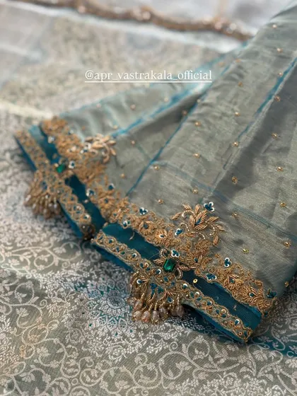 A sleeve with a sheer panel and intricate cuff embroidery.