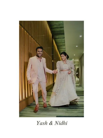 Walking hand-in-hand into their future. This shot captures the couple's happy stride down a modern corridor, symbolizing the start of their journey together.