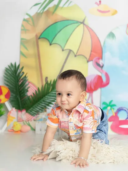 Let's go to the beach! This summer-themed shoot is full of bright colors and fun props like flamingos and beach balls.
