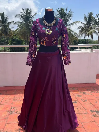 The full view of the purple embroidered lehenga, a great choice for a wedding guest.