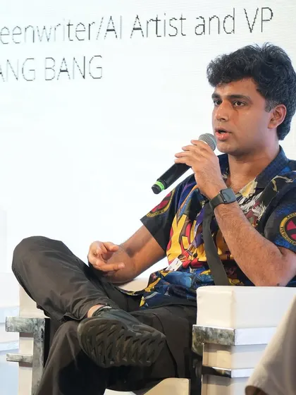 A close-up of me speaking at Film Bazaar. I'm wearing a shirt with my own 'Parmanupunk' designs on it.