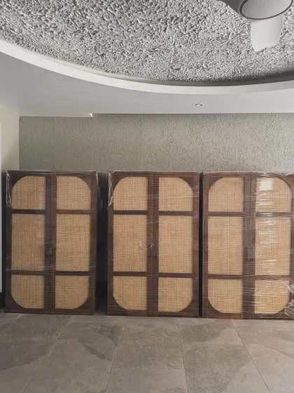 Three of the wardrobes wrapped and ready for delivery, seen here inside the client's property.