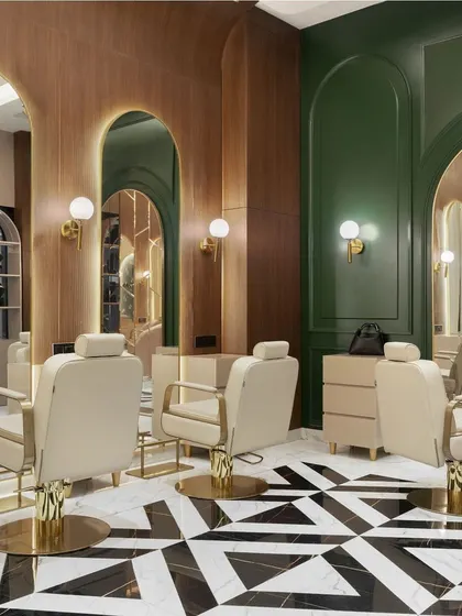 Another angle of the makeup studio, highlighting the interplay between the geometric floor, the rich green walls, and the warm, arched wood panels.