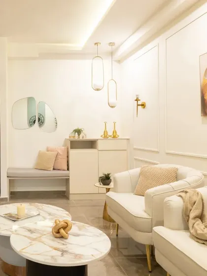 This stunning living room is a masterclass in luxury. I combined beige and gold hues, a marble coffee table, and sleek, modern furniture to create a space crafted for comfort and style.