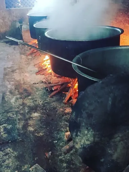 Cooking for a large event in Tirunelveli. The steam rising from the pots over the wood fire shows the traditional and large-scale preparation we are known for.