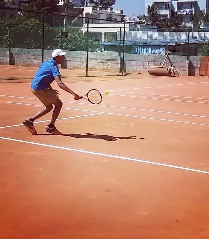 A player reaches for a forehand shot during an Open Tournament match.