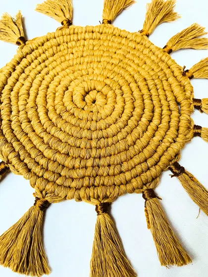 This angled close-up highlights the craftsmanship of the knots and the texture of the tassels. It shows how the piece adds a three-dimensional, tactile quality to your decor.