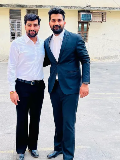 Standing with a colleague outside the court. Lawyers are indeed a pillar of society, responsible for upholding the rule of law.