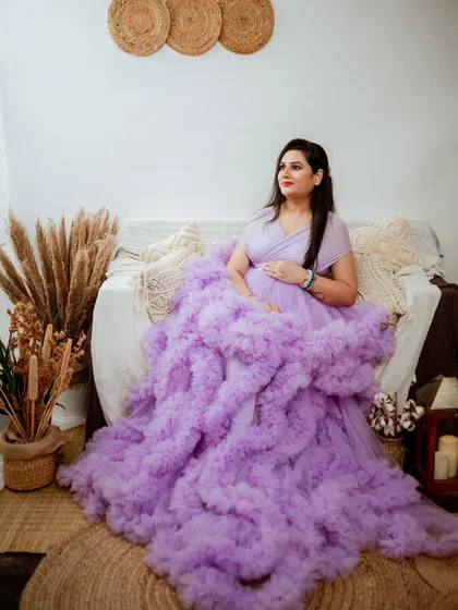 This stunning lavender ruffled gown is part of our extensive client wardrobe. Its voluminous design creates incredible texture and a high-fashion look, making it a perfect choice for a memorable studio portrait.