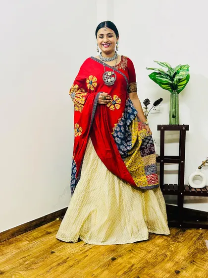 Another look at my Navratri outfit. The combination of red, cream, and indigo with traditional prints creates a vibrant and celebratory feel.