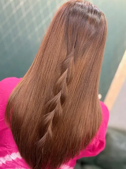 A simple yet elegant waterfall braid on long, straight hair with a beautiful brown color. This shows how a great color can elevate even a simple style.