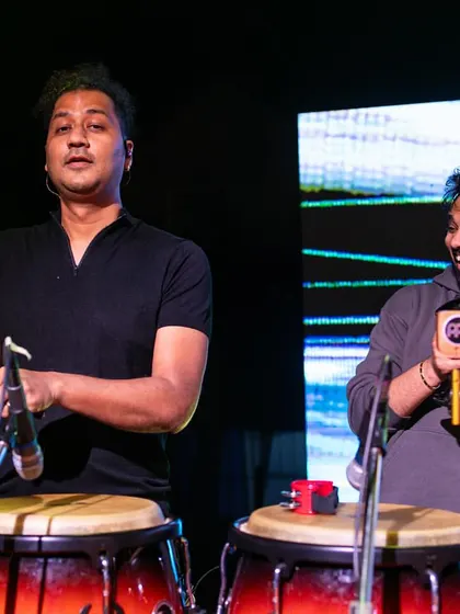 Sharing a moment with a fellow musician on stage. Collaboration is key, and here I'm playing the bar chimes to add a touch of melodic percussion.
