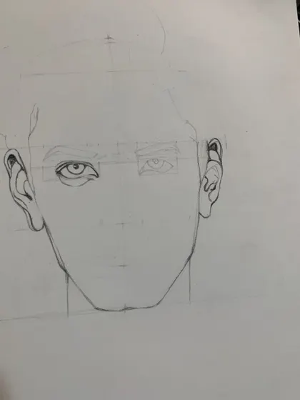 A student practices the basic construction of a face, an essential step before adding details and shading in our charcoal portraiture course.