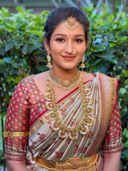 A smiling portrait of the sister of the bride, her makeup kept fresh and glowing.