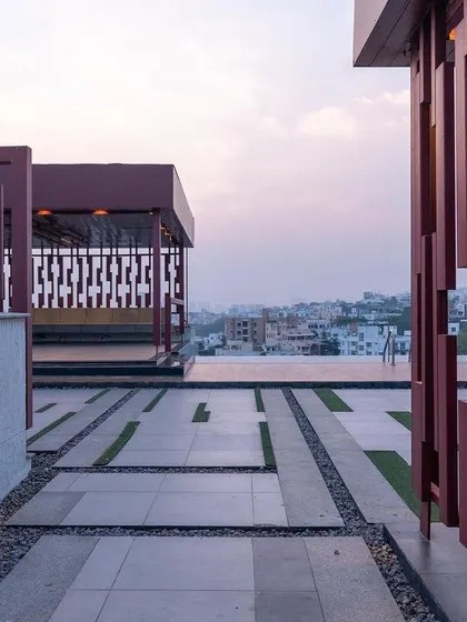 The terrace of this luxury apartment in Jubilee Hills is designed as a community space to unwind. The infinity pool is positioned to overlook the lake, creating a stunning visual effect.