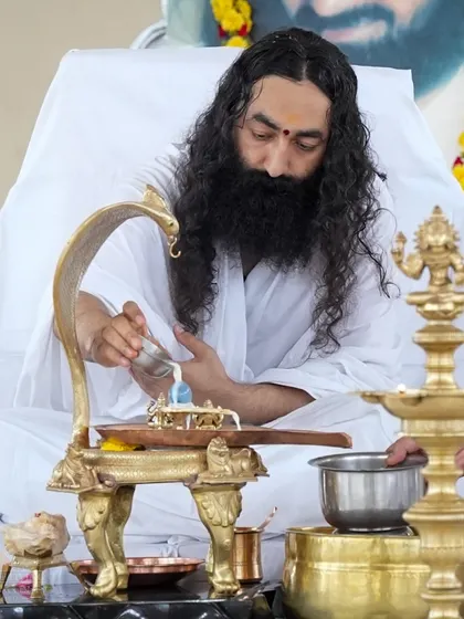 A senior teacher performs Abhishekam during the Rudra Puja. It is a blessing to have such dedicated individuals who uphold the sanctity of these rituals.