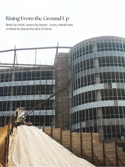 A photograph of the Infotech Centre during construction. This image captures the moment the structure was rising from the ground, showing the concrete and steel skeleton that would soon be clad in its iconic glass facade.