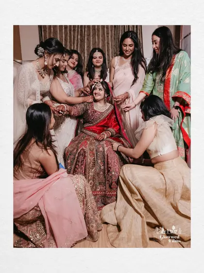 A heartwarming photo of the bridesmaids surrounding the bride, showering her with love and affection.