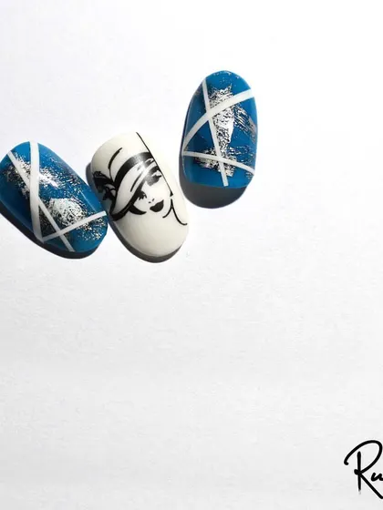 More fun with stamping art. The combination of blue foil and a graphic face stamp creates a cool, abstract look.