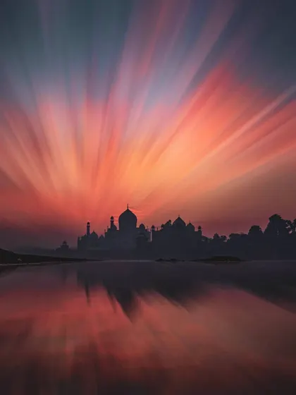 The Taj Mahal is transformed by a dramatic, colorful sky created with a long exposure zoom-burst technique. This artistic travel photograph shows how creative methods can offer a fresh look at iconic landmarks.